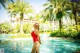 A woman in a red bathing suit standing in a pool.