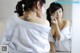 A woman with a tattoo on her back looking at herself in the mirror.