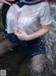 A woman in a sailor outfit is standing in the water.