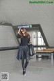 A woman walking through an airport with a backpack.