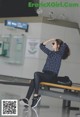 A woman sitting on a bench in an airport.